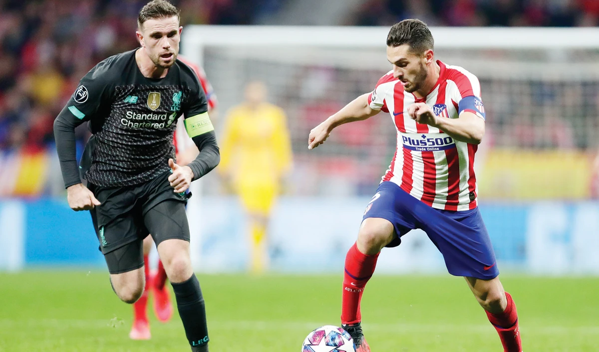 Atletico Madrid’s Koke controls the ball as Liverpool’s Jordan Henderson defends during a recent match at the Wanda Metropolitano stadium in Madrid. AP