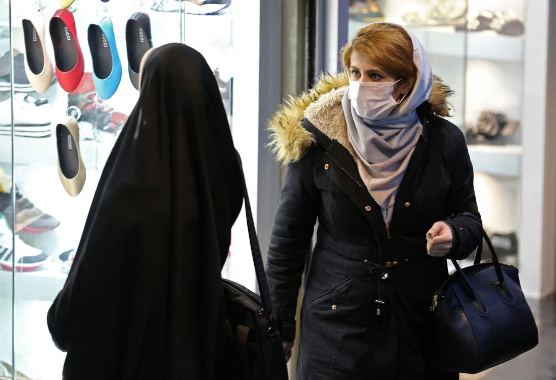 An Iranian woman wearing a protective mask walks in a street in the capital Tehran on February 20,2020. (AFP)