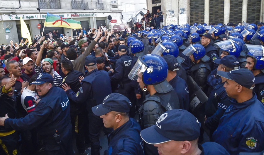 Members of the Algerian police block the progress of an anti-government demonstration heading toward the presidential palace in Algiers on Saturday. (AFP)
