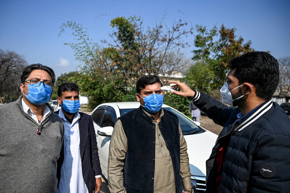 Pakistan closed its land border with Iran, while Afghanistan suspended travel to the neighboring country as fears across the region continued to grow over a jump in new coronavirus infections. (File/AFP)