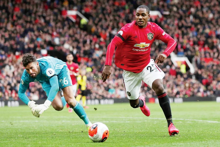 Manchester United’s Odion Ighalo in action with Watford’s Ben Foster during Sunday’s English Premier League football match in Manchester. (Reuters)