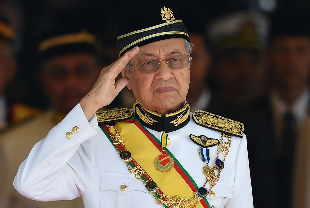 Malaysia's Prime Minister Mahathir Mohamad salutes the royal guard of honor during the opening ceremony of the parliament in Kuala Lumpur. (AFP)