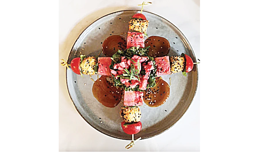 watermelon salad, with kale, cherry tomatoes, refreshing diced watermelon, fried feta cheese, and balsamic vinaigrette. (Photo/Supplied)