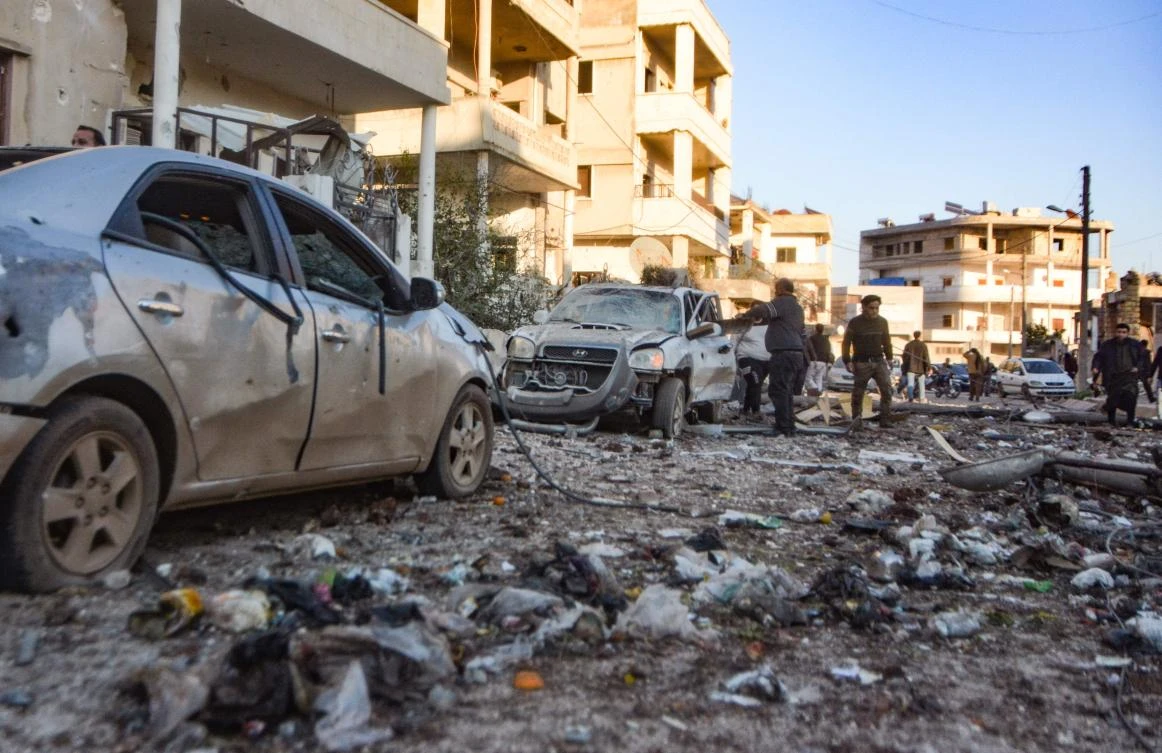 People check the damage in a street following an air strike by pro-Syrian regime forces in the town Maarrat Misrin in Syria’s northwestern Idlib province, on February 25, 2020. (AFP)