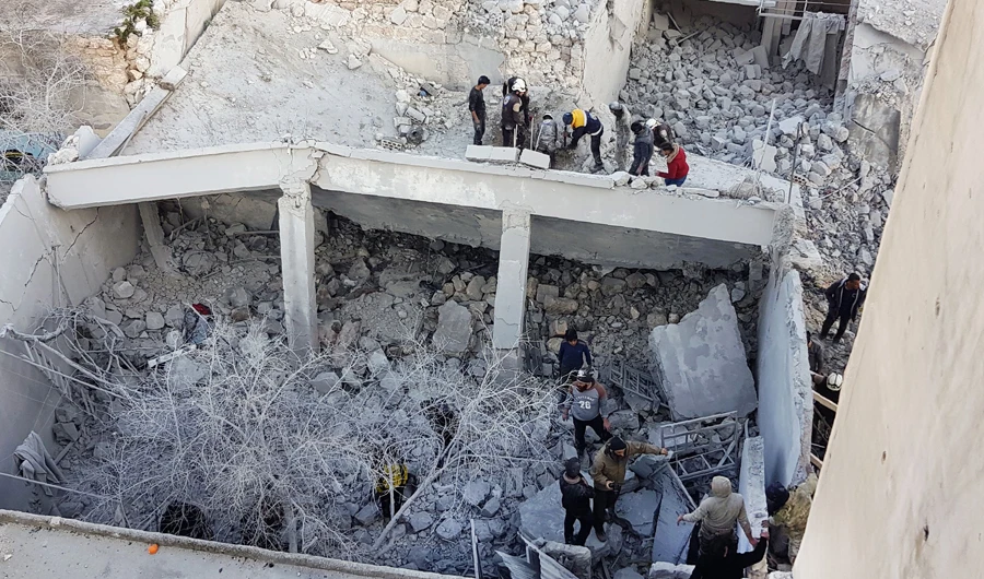 Syrians search for victims following an airstrike by pro-regime forces in Binnish, Idlib, near the border with Turkey. (AFP)