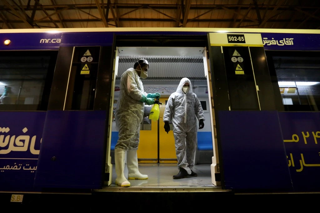 Tehran Municipality workers clean a metro train to avoid the spread of coronavirus on February 26, 2020. (AFP)