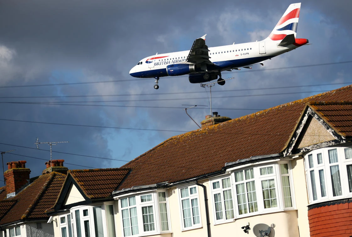 A British Airways A319 aircraft arrives over the top of residential houses to land at Heathrow Airport in west London, Britain. (Reuters)