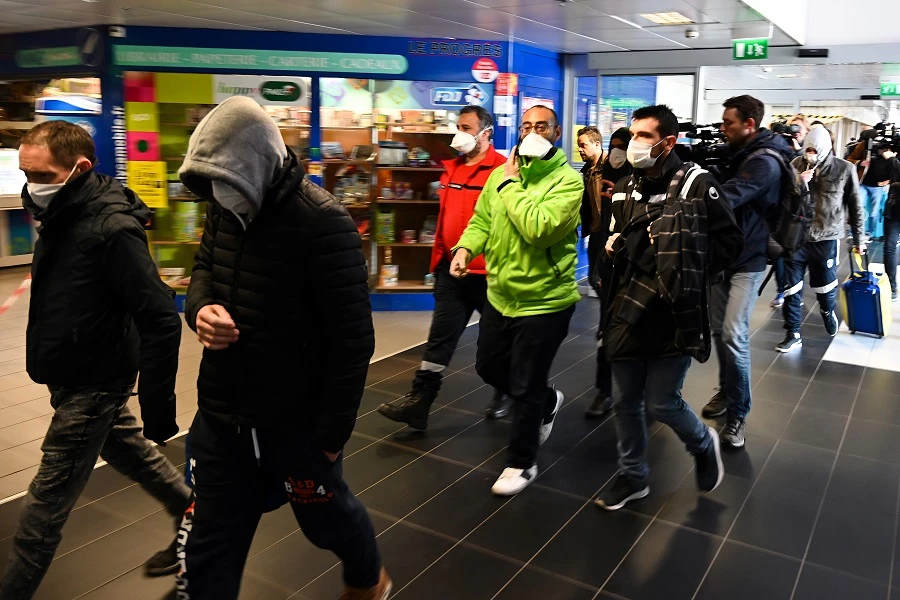 People wearing protective facemask are evacuated from the security zone where a bus comming from Milan is blocked at the train and bus station Lyon Perrache, due to suspected COVID-19 the novel coronavirus on board, in Lyon, on February 24, 2020. (File,AFP)