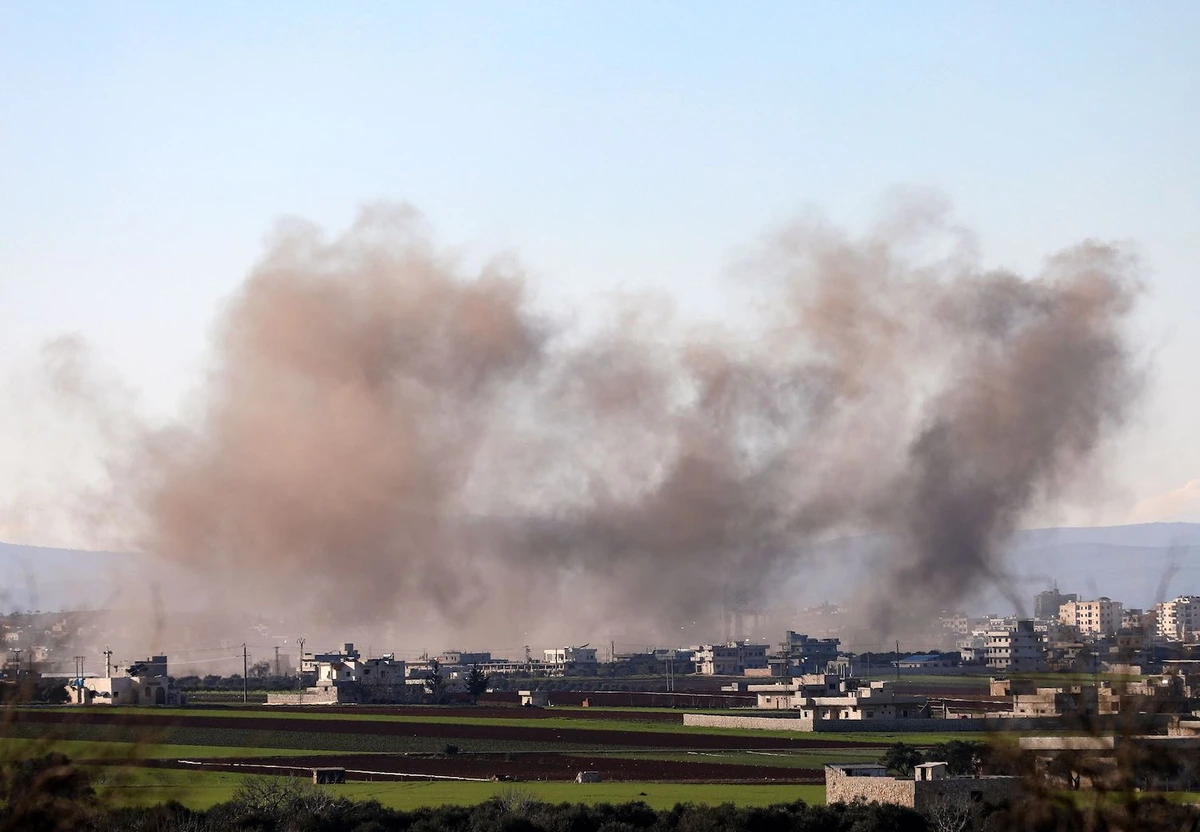 Smoke billows above the rebel-controlled town of Binnish near the town of Saraqeb, east of the Idlib province in northwestern Syria, on Feb. 26, 2020, during air stikes by pro-regime forces. (AFP)