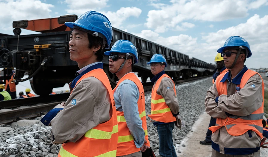 Chinese workers stand at the construction site of Railway on June 23, 2018. (AFP)