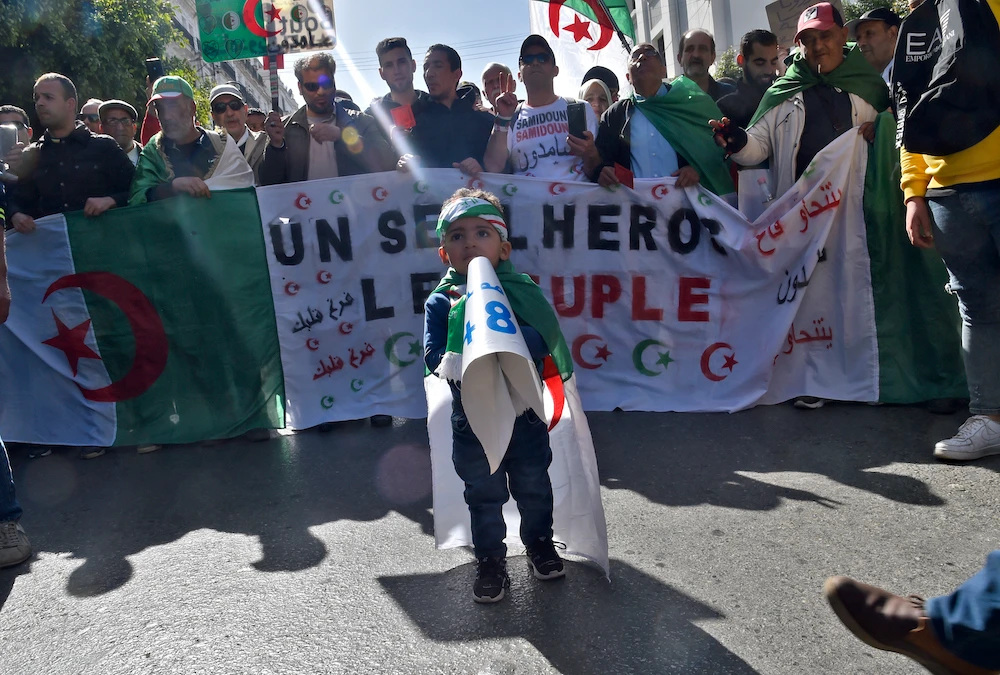 Algerian demonstrators wave the national flag during a demonstration in the capital Algiers, on February 28, 2020. (AFP)