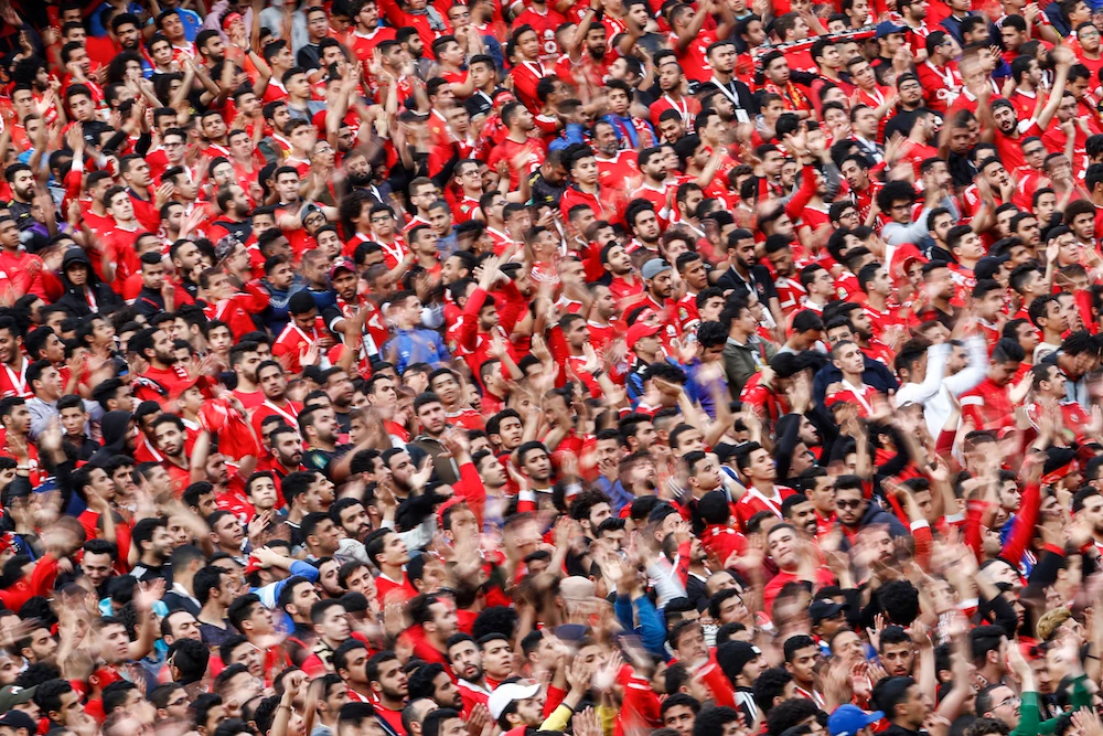Egypt's Ahly SC football fans cheer for their team ahead of the first leg of the CAF Champions League Quarter-final football match between Egypt's Al-Ahly and South Africa's Mamelodi Sundowns at Cairo International Stadium in Cairo. (AFP)