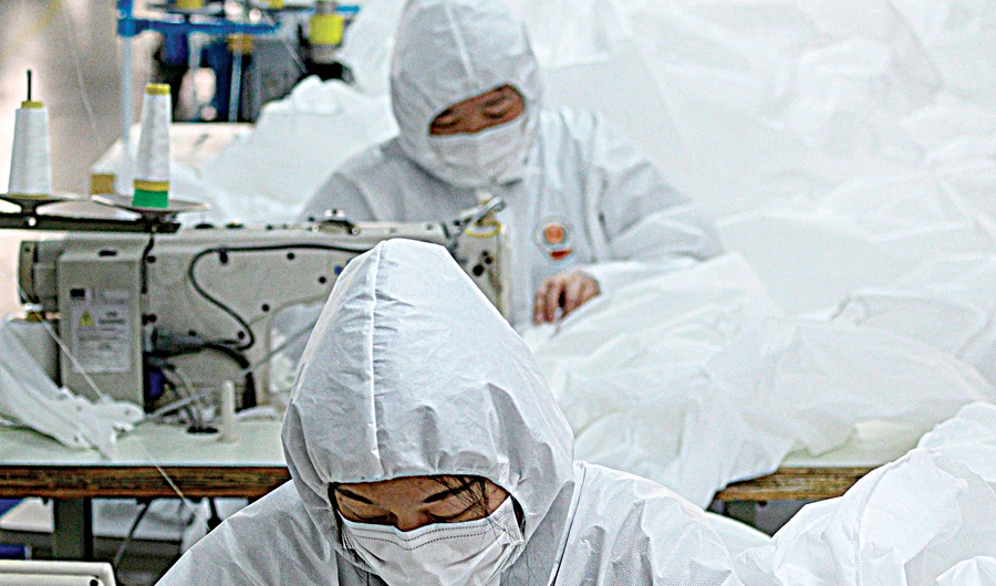 Workers making the hazmat suits at the Wenzhou factory also wear the protective outfits to prevent contamination. (AFP)