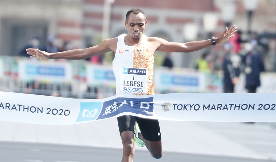 Birhanu Legese of Ethiopia crosses the finish line to win the men’s category in the Tokyo Marathon on Sunday. (AFP)
