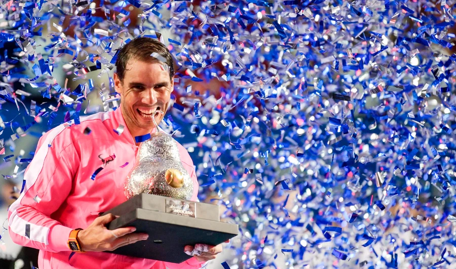 Spain's Rafael Nadal Rafael Nadal bites the trophy after winning the Mexican Tennis Open ATP final match against USA's Taylor Fritz during the Mexico ATP Open men's singles tennis final in Acapulco, Guerrero state on February 29, 2020. (AFP)