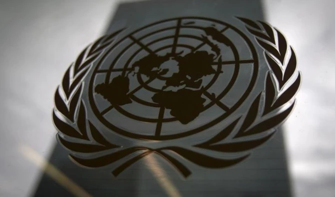 The United Nations headquarters building is pictured through a window with the UN logo in the foreground in the Manhattan borough of New York, Aug. 15, 2014. (REUTERS)