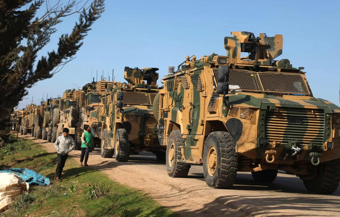 A Turkish military convoy parked near the town of Batabu on the highway linking Idlib to the Syrian Bab Al-Hawa border crossing with Turkey. (AFP)