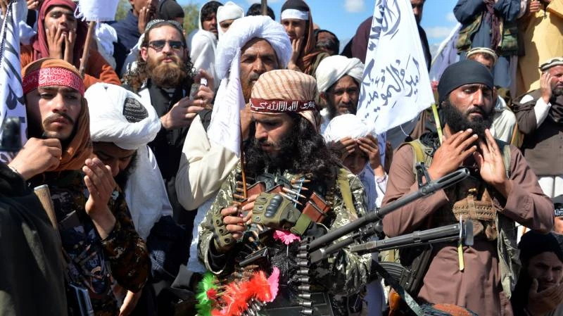 Afghan Taliban militants and villagers attend a gathering as they celebrate the peace deal and their victory in the Afghan conflict on US in Afghanistan, in Alingar district of Laghman Province. (AFP)
