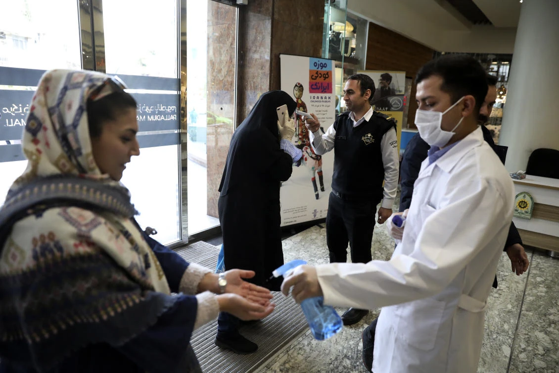 People have their temperature checked and their hands disinfected as they enter the Palladium Shopping Center, in northern Tehran, Iran, Tuesday, March 3, 2020. (AP)