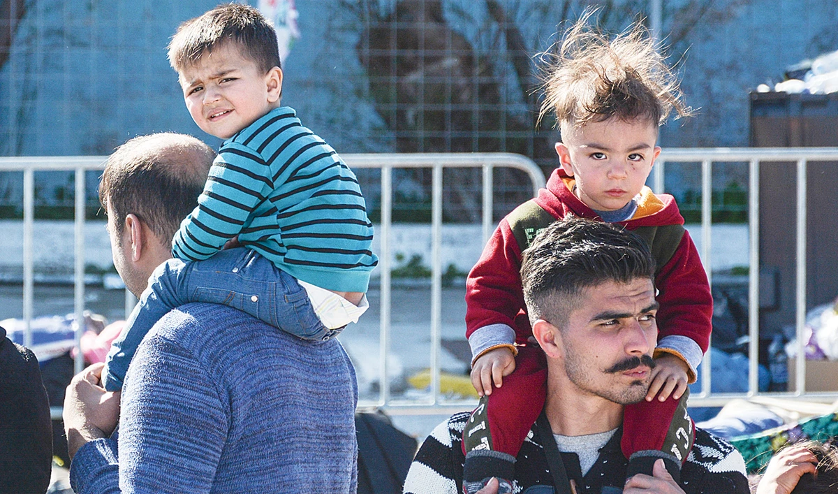 Migrants and their children at the port of Mytilene on the northeastern Aegean island of Lesbos, Greece. (AP)