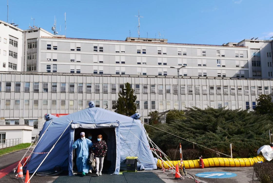 A woman leaves the a pre-triage medical tent in front of the Cremona hospital, in Cremona, northern Italy, on March 4, 2020. Italy will recommend people stop kissing in public, avoid shaking hands and keep a safe distance from each other to limit the spread of the novel coronavirus. Other measures to be approved by the government, which has borne the brunt of the COVID-19 disease, includes a plan to play all football matches behind closed doors.(AFP)