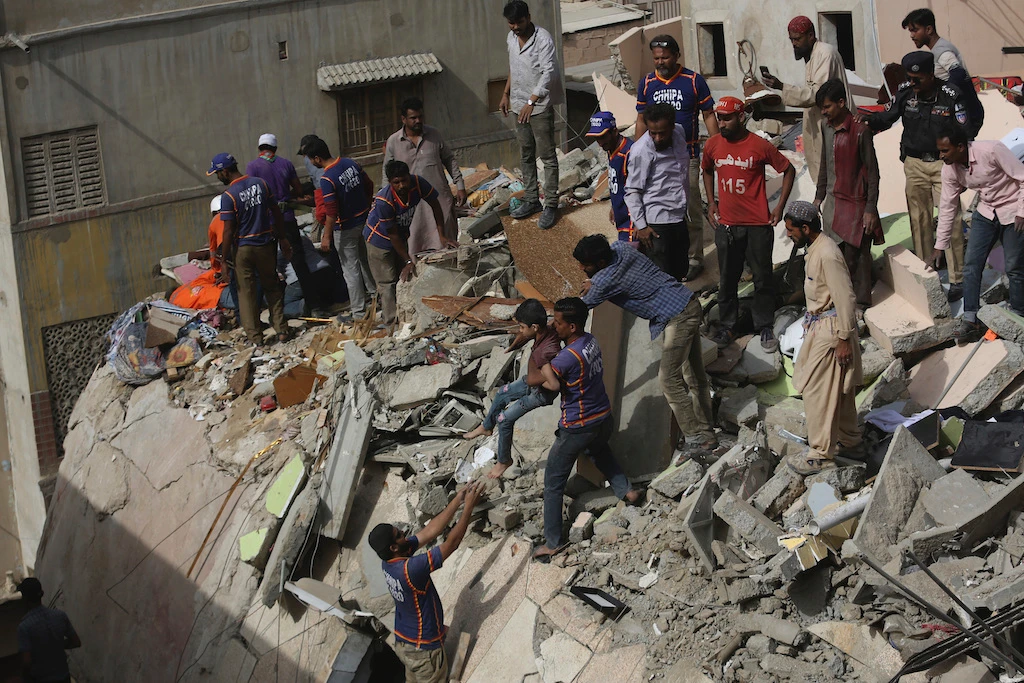Pakistani volunteers look for survivors amid the rubble of a collapsed building in Karachi, Pakistan, Thursday, March 5, 2020. (AP)