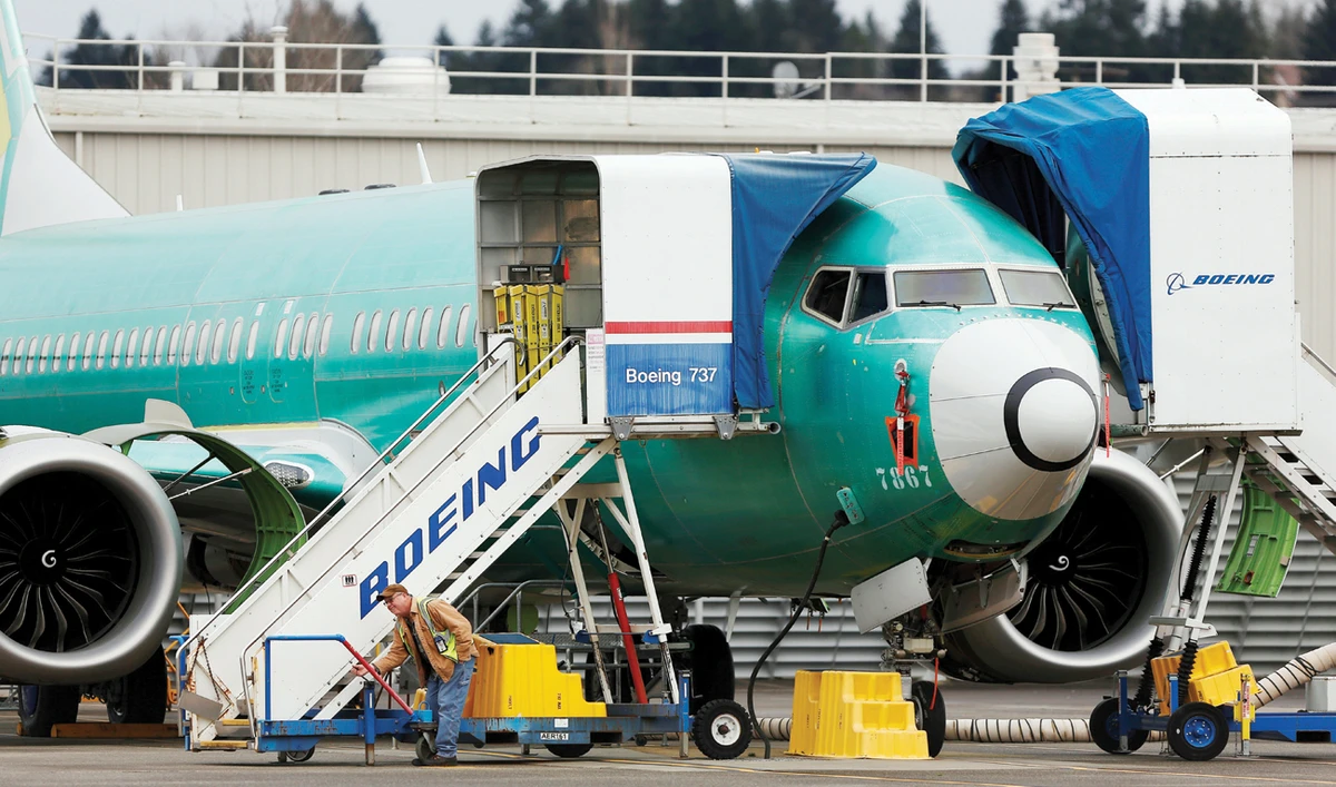 An employee works near a 737 MAX aircraft at Boeing’s 737 Max production facility in Renton, Washington. The MAX remains grounded worldwide. (File/Reuters)
