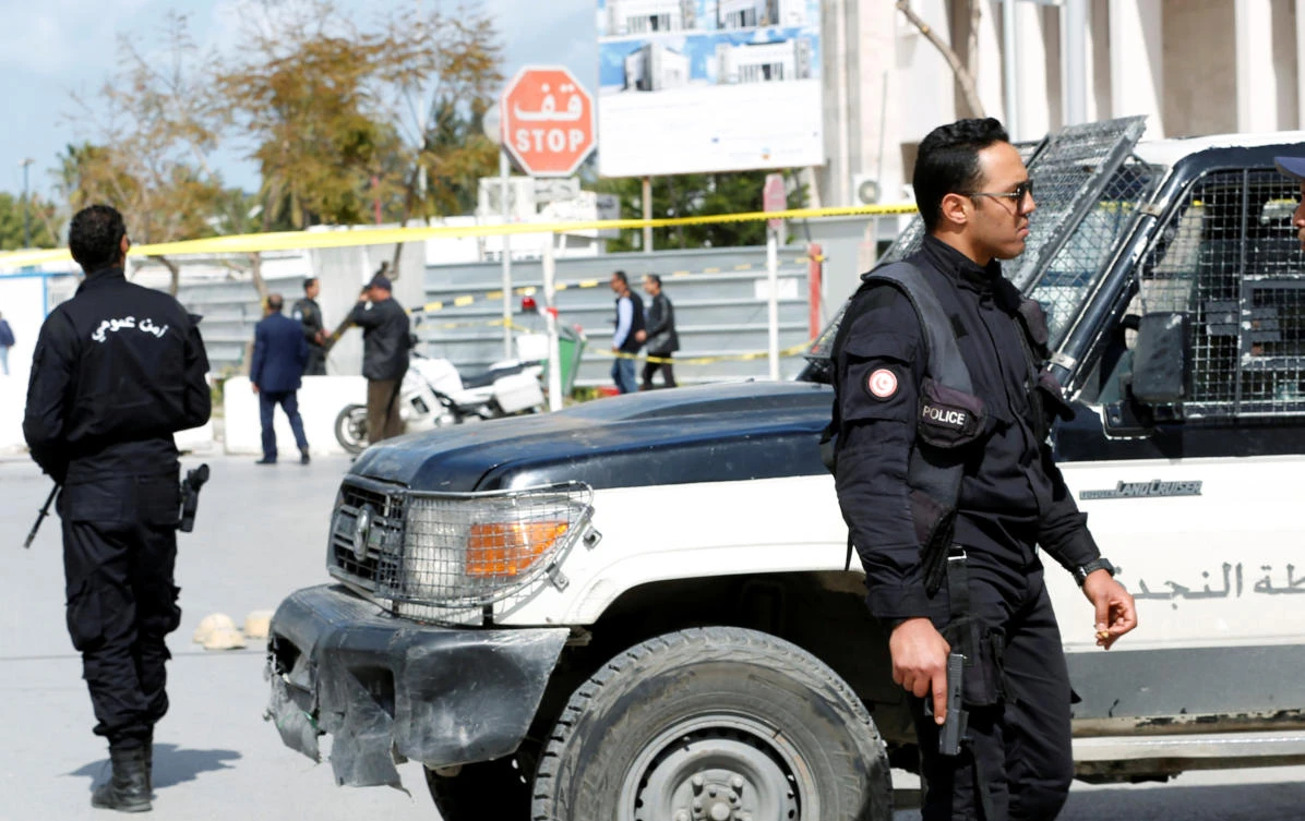 A police officer carries a gun as he stands guard near the site of a suicide attack that occurred outside the US embassy in Tunis, Tunisia March 6, 2020. (Reuters)