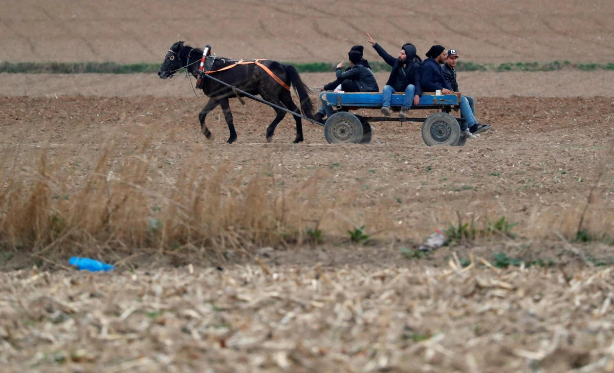 Migrants on a horse and carriage near Turkey’s Pazarkule border crossing with Greece’s Kastanies, near Edirne, Turkey. (Reuters)