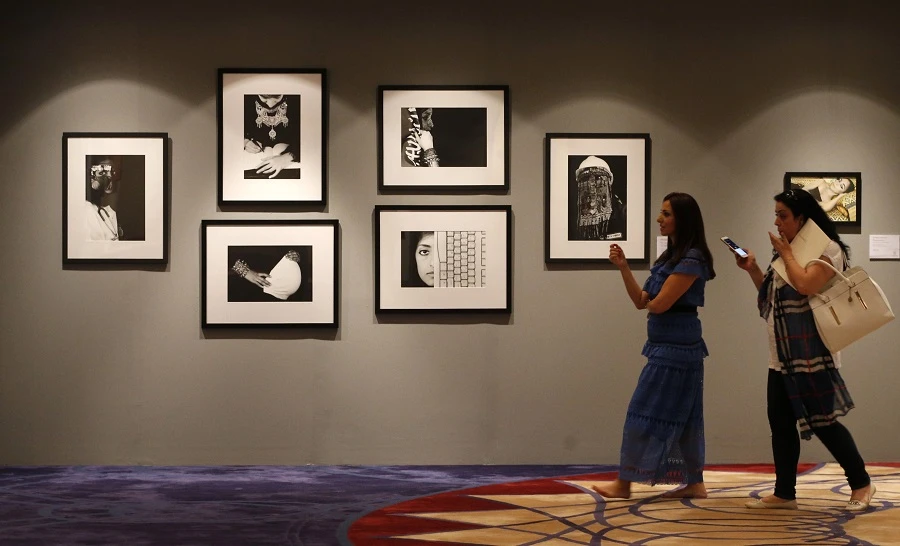 Visitors look at art work by Saudi artist Manal al-Dowayan displayed at a Christie's exhibition in Dubai. (File/AFP)