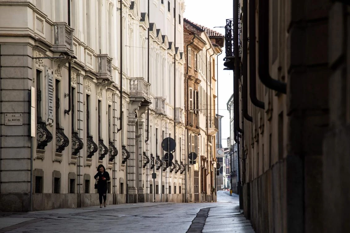 A girl walks in Corso Vittorio Alfieri on March 8, 2020 in Asti, a new quarantine zone in Northwestern Italy. A quarter of the Italian population was locked down on March 8, 2020 as the government takes drastic steps to stop the spread of the deadly new coronavirus that is sweeping the globe, with Latin America recording its first fatality. (AFP)