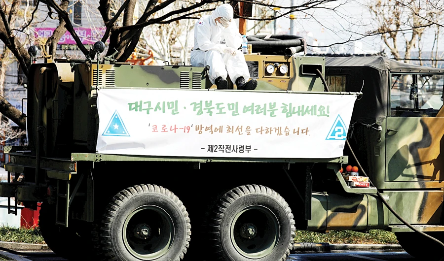 A soldier sits atop a military vehicle for quarantine work at a screening facility for virus patients at a hospital in Daegu, South Korea, on Sunday. (Reuters)