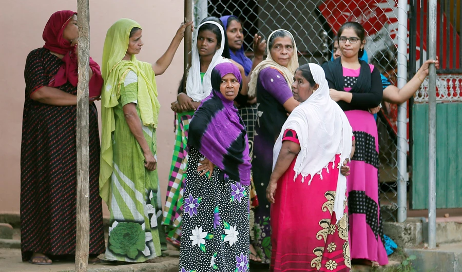 Women react on a road during curfew after a mob attack in Kottampitiya, Sri Lanka May 14, 2019. (REUTERS)