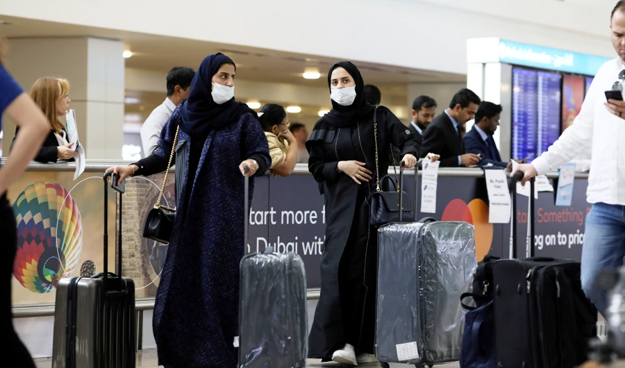 Travellers wear masks as they arrive at Dubai International Airport, after the UAE's Ministry of Health and Community Prevention confirmed the country's first case of coronavirus, in Dubai, United Arab Emirates January 29, 2020. (REUTERS)