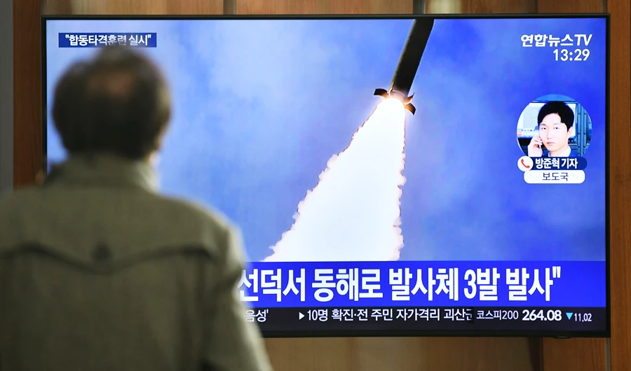 A man watches a television news broadcast showing a file image of a North Korean missile test, at a railway station in Seoul on March 9, 2020. Nuclear-armed North Korea on March 9 fired what Japan said appeared to be ballistic missiles, a week after a similar weapons test by Pyongyang. (AFP)