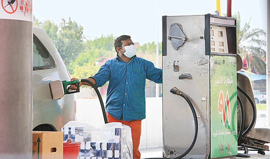 A foreign worker wearing a protective mask fills a car tank at a petrol station in Qatif city in Saudi Arabia’s Eastern Province, some 400km from Riyadh. (AFP)