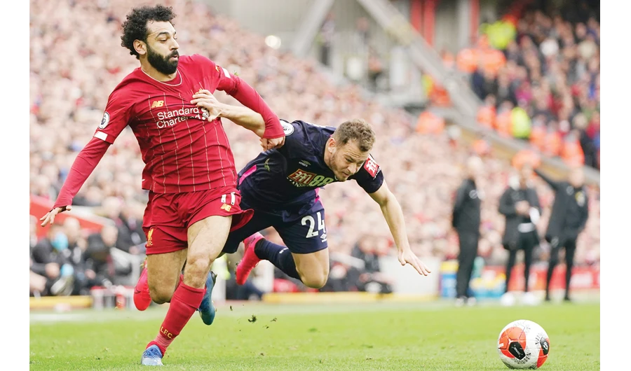 Liverpool’s Mohamed Salah, left, challenges for the ball with Bournemouth’s Ryan Fraser during Saturday’s English Premier League soccer match in Liverpool. (AP)