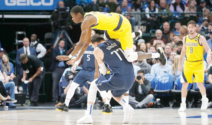Dallas Mavericks guard Luka Doncic (77) is fouled by Indiana Pacers guard Edmond Sumner (5) during an NBA game in Dallas. (AP)