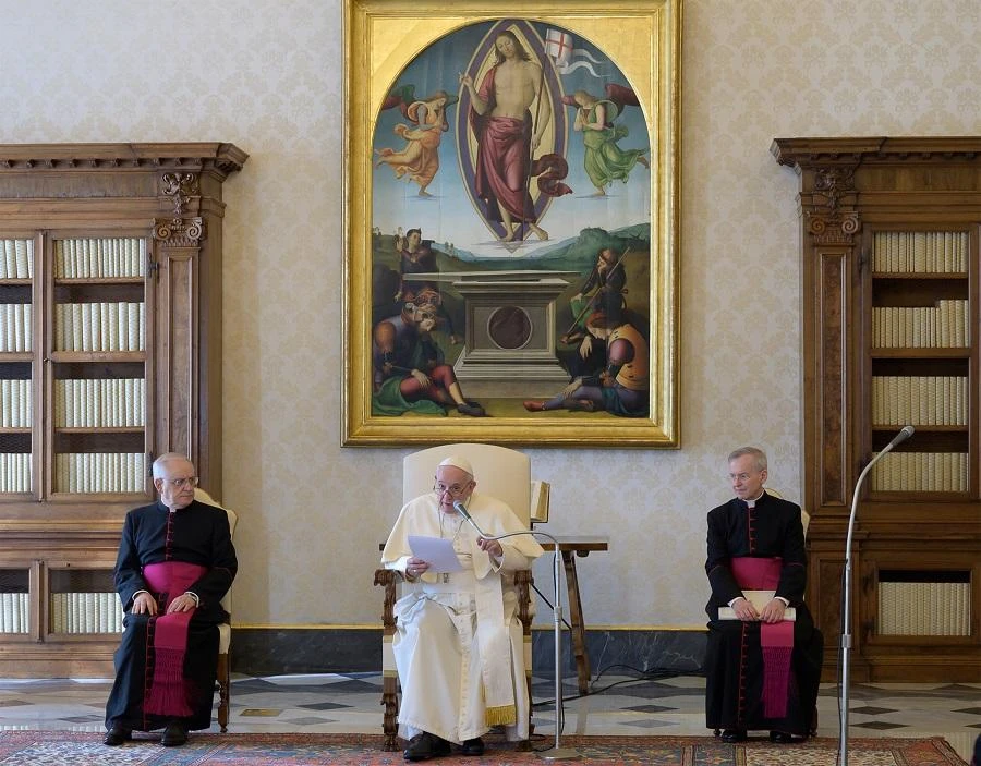 This photo taken and handout on March 11, 2020 by the Vatican Media shows Pope Francis (C), flanked by Monsignor Leonardo Sapienza (L) and Monsignor Luis Maria Rodrigo Ewart, holding a private and restricted weekly general audience in the library of the Apostolic Palace in the Vatican, as part of precautionary measures against the spread of the new COVID-19 coronavirus. (File/AFP)