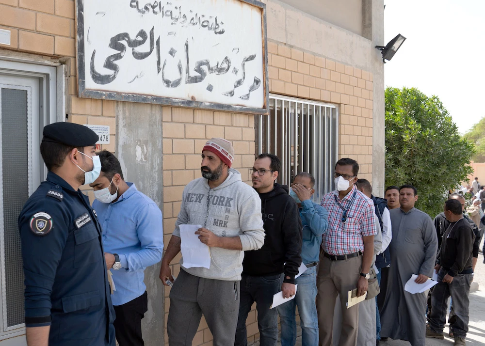 Expatriates are seen in line as they need to take a coronavirus clearance certificate, after returning from vacations, following the outbreak of the virus, at a health clinic in Subhan, Kuwait March 9, 2020. (Reuters)
