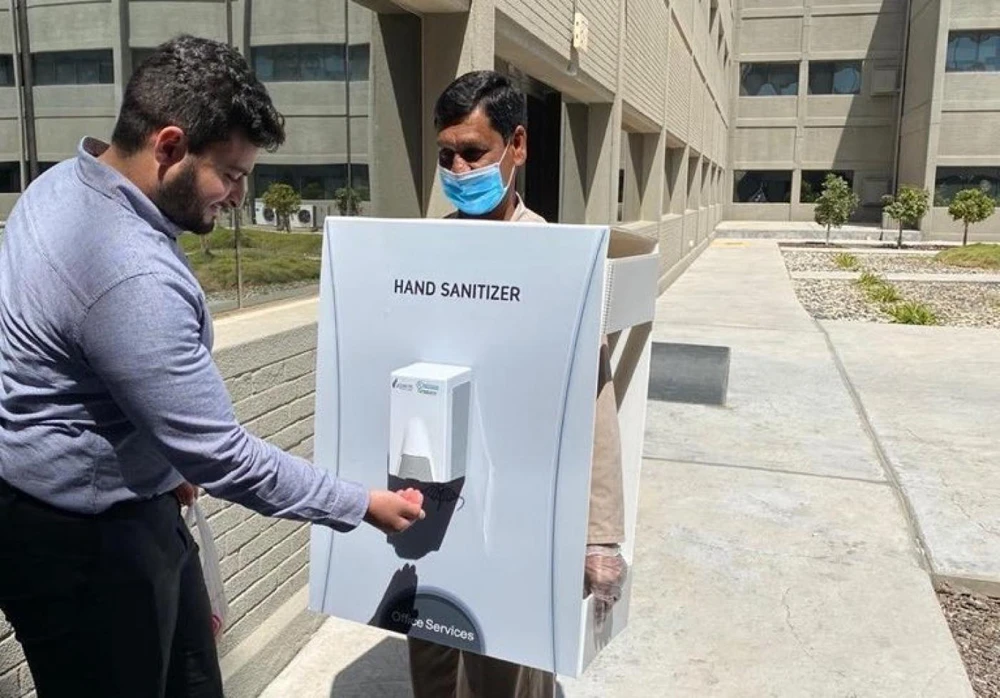Saudi Aramco attracted criticism after an image was circulated online of a masked employee walking around Saudi Aramco’s offices wearing a body suit with a hand sanitizer attached. (Supplied)
