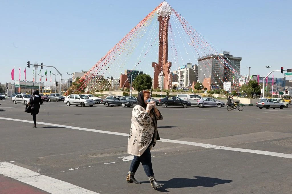 The coronavirus death toll in Iran has risen to to 354 amid over 9,000 cases. Above, a pedestrian crosses a street while wearing a protective mask in Tehran. (AFP file photo)