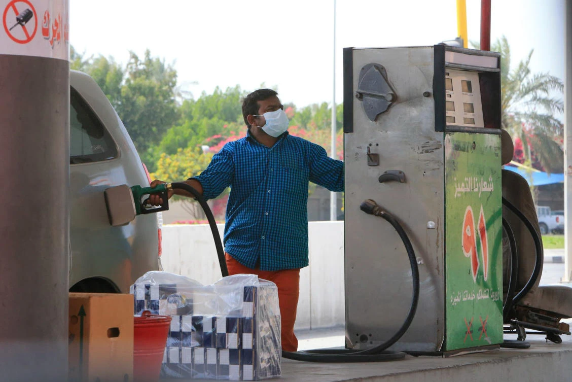 A foreign worker wearing a protective mask fills a car tank at a petrol station in Qatif city in the Eastern Province, some 400Km from the capital Riyadh, on Mar. 9, 2020. (AFP)
