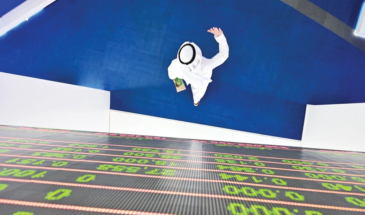 A stock display board at the Dubai Stock Exchange in the UAE. Saudi stocks have retreated by 3 percent with Saudi Aramco shares about 2.4 percent lower. All seven Gulf exchanges ended the week with heavy losses. (AFP)