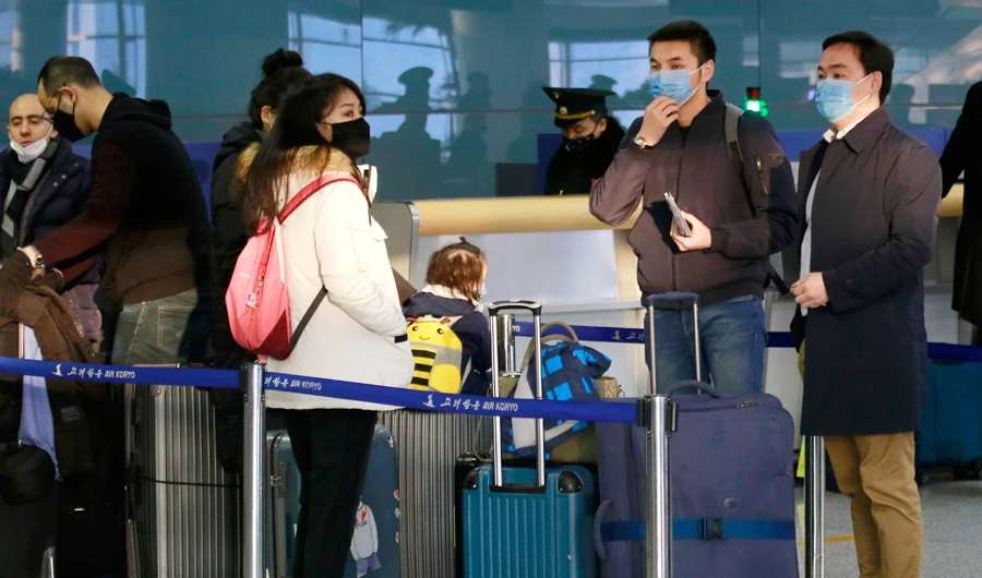 Passengers wearing masks as a precaution against a new coronavirus line up to check in for a flight to Vladivostok, Russia, at the Pyongyang International Airport in Pyongyang, North Korea, Monday, March 9, 2020. (AP)
