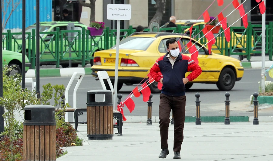 A man wearing a face mask walks along a street in Tehran on Saturday. (AFP)