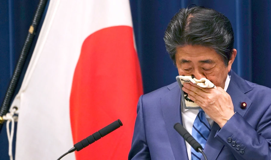 Japanese Prime Minister Shinzo Abe wipes his face as he answers a question during his press conference in Tokyo on Saturday. (AP)