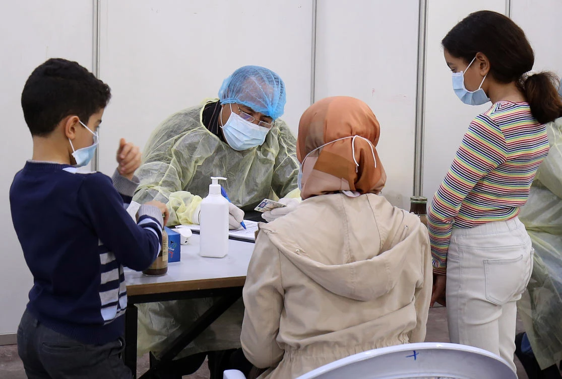 People being tested at a Kuwaiti health ministry containment and screening zone for COVID-19 in Kuwait City. (AFP)