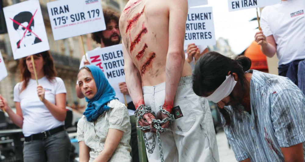 Reporters Without Borders activists take part in a protest in front of an Iran Air agency in Paris, on 10 July 2012 to denounce journalists’ imprisonment in Iran. (AFP)