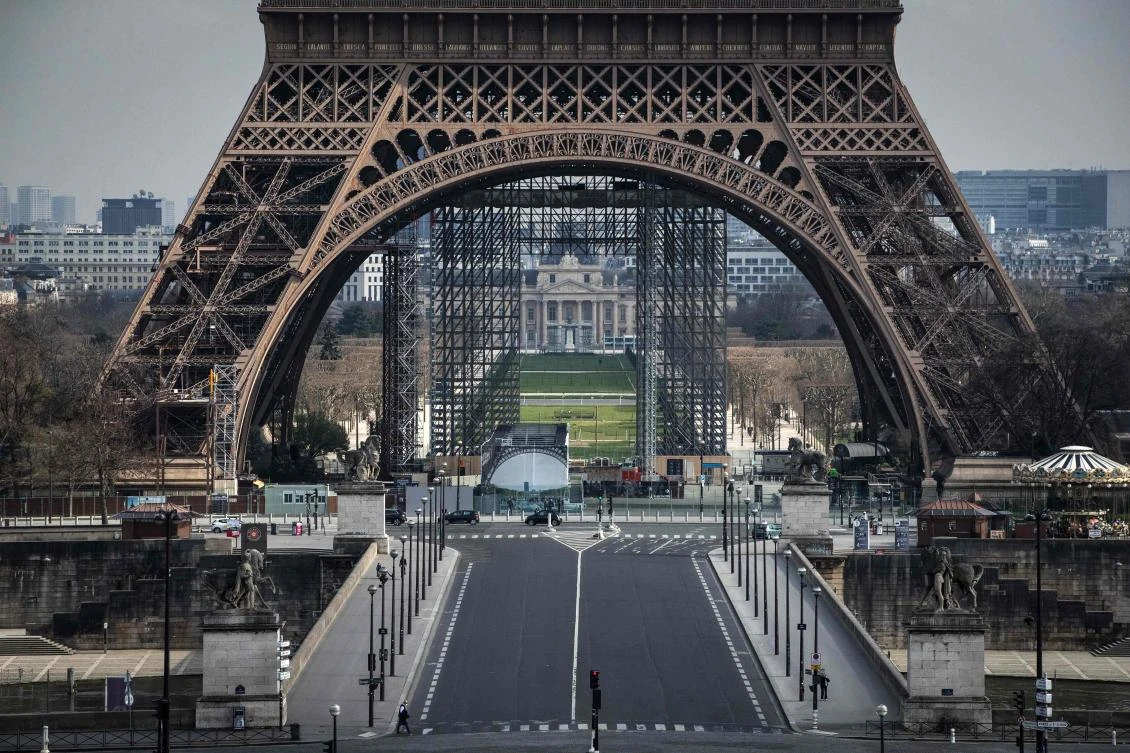 An empty street near the closed Eiffel Tower while a strict lockdown comes into effect in France to stop the spread of COVID-19, caused by the novel coronavirus. (AFP)